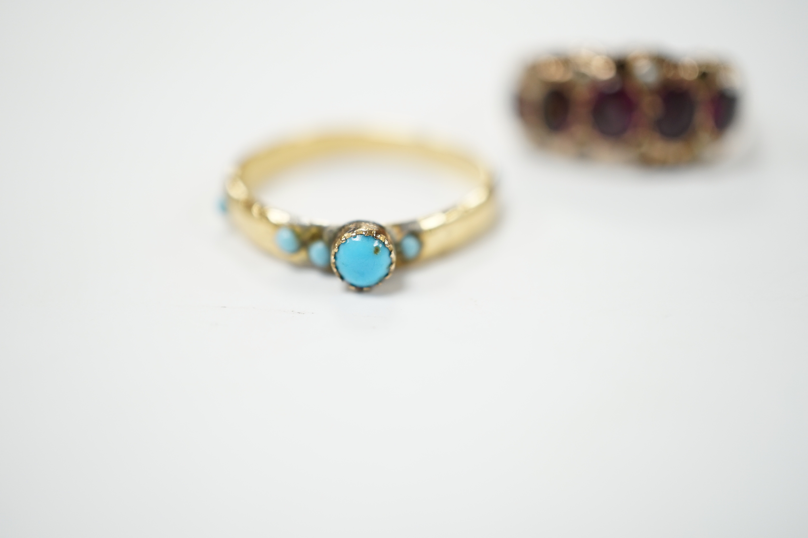 A Victorian garnet and seed pearl dress ring, size O, and a turquoise set yellow dress ring, size K